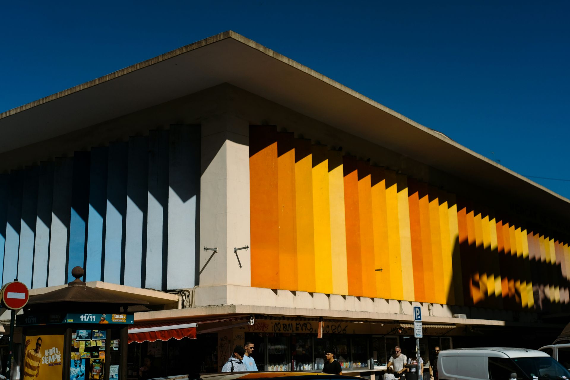 Modern building with colorful striped facade under blue sky